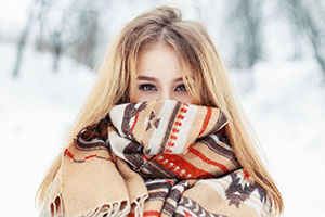 woman wearing a coat and scarf around her face