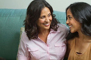 caregiver is speaking to a teenage girl