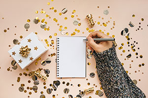 handwriting on a notepad with new years confetti on the table